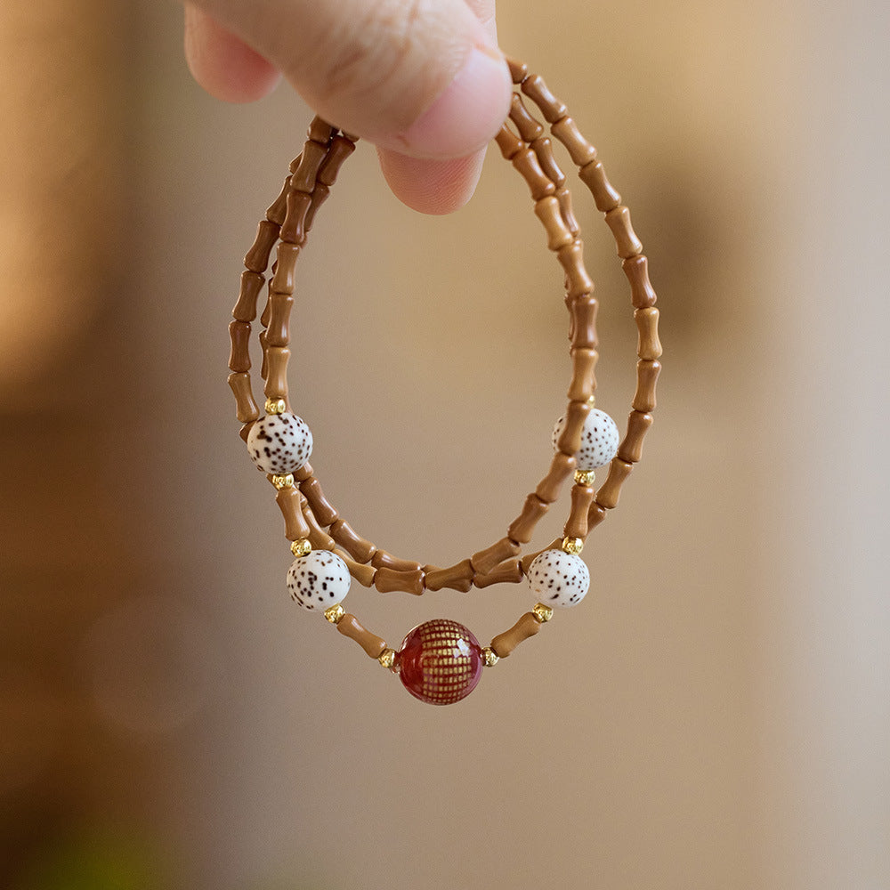Bamboo olive kernel strand with “Heart Sutra” red agate