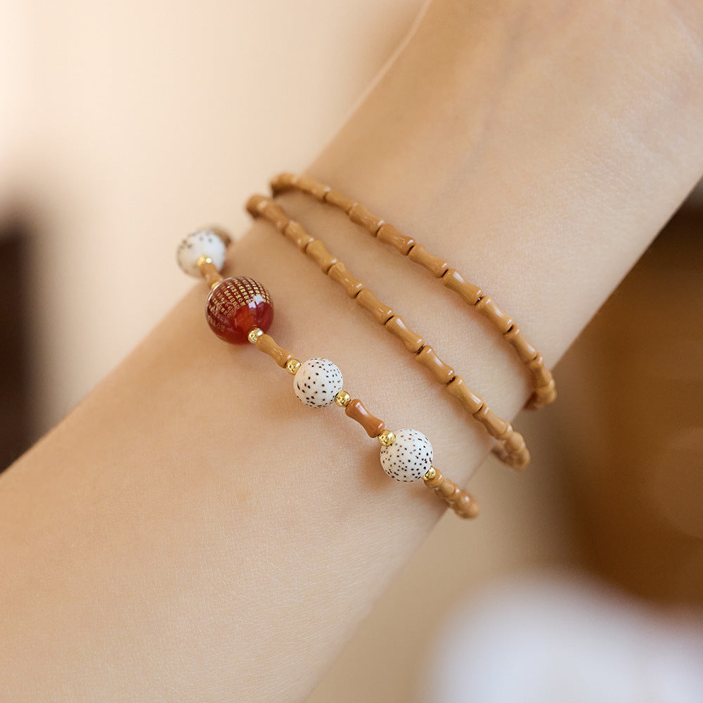 Bamboo olive kernel strand with “Heart Sutra” red agate