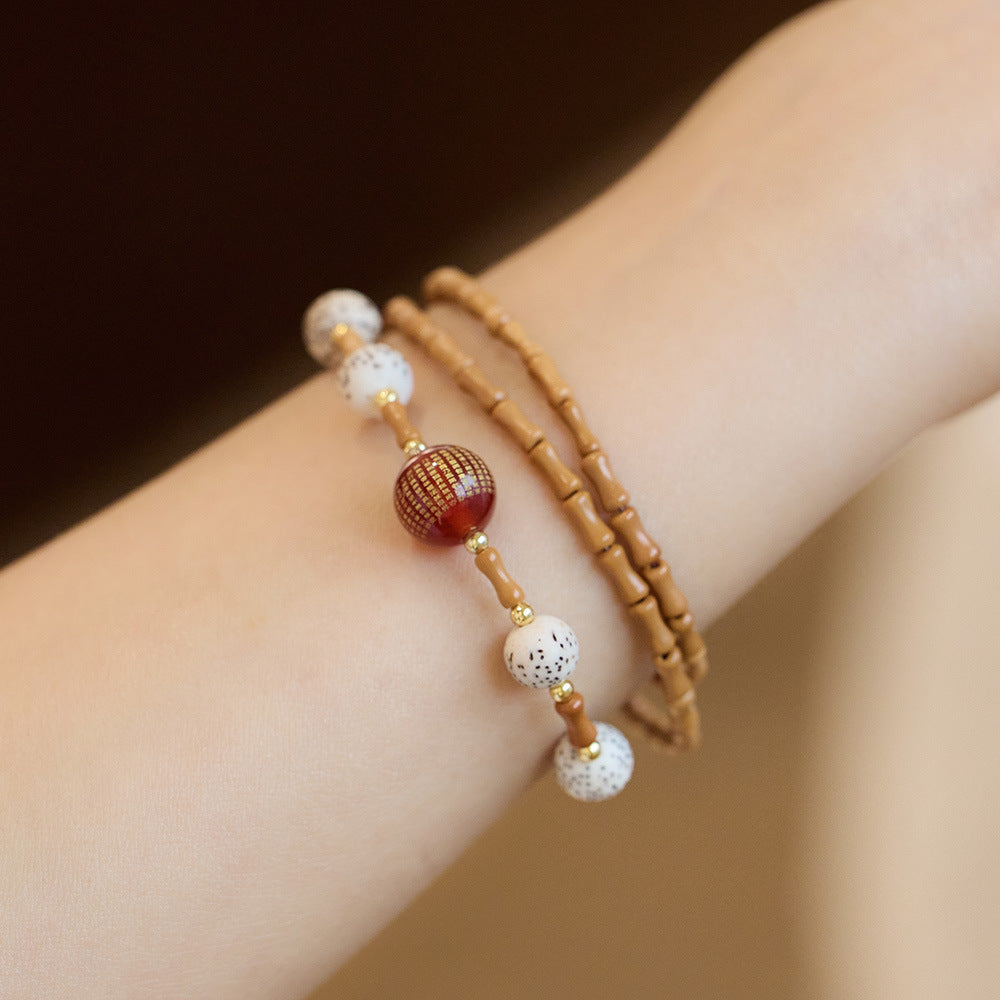 Bamboo olive kernel strand with “Heart Sutra” red agate