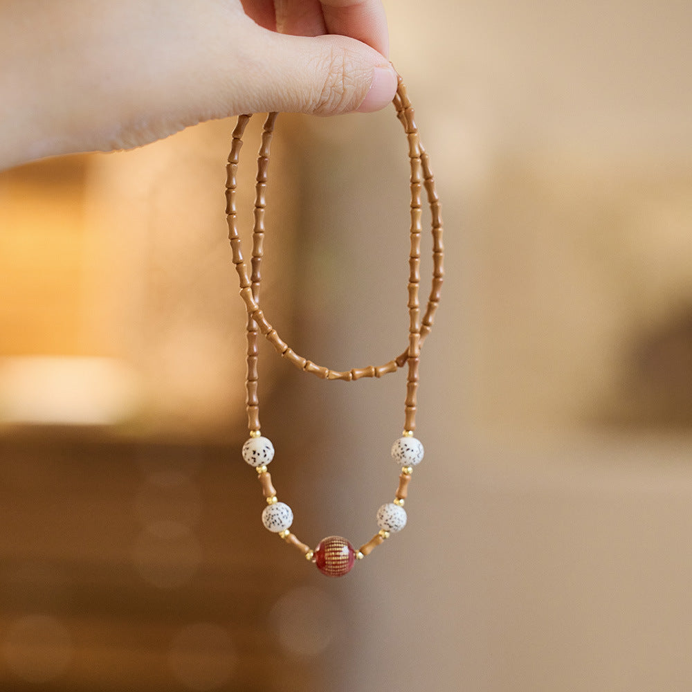 Bamboo olive kernel strand with “Heart Sutra” red agate